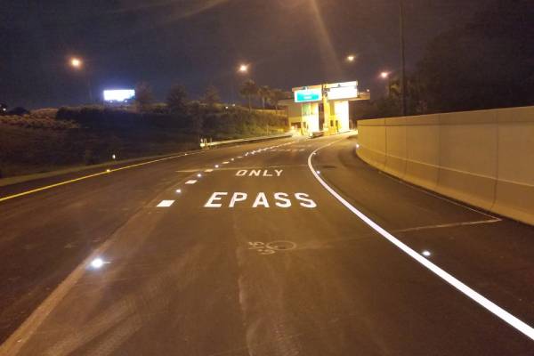 Close-up of temporary tape application during pavement marking services provided by McShea